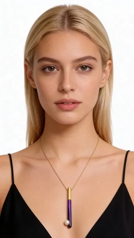 Discover the unique beauty of this striking color block pendant necklace, which harmoniously combines golden brass with bold purple enamel and a delicate pearl. Designed by Greek Jewelry Designer Aikaterini Chalkiadaki, this handmade piece is the perfect choice for the modern woman seeking statement accessories with a Greek signature.

The short necklace features a geometric pendant that ends in a natural pearl, creating a refined blend of traditional and modern elements. The bold purple hue combined with the golden brass offers a luxurious feel that catches every eye.

Ideal for everyday or evening wear, this necklace pairs beautifully with monochrome outfits and can be worn alone or in a layered look with other jewelry.

Care for your jewelry by storing it in a dry place and cleaning it with a soft cloth to preserve its shine.