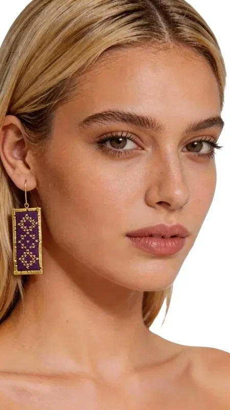 The statement embroidered earrings with geometric patterns in gold thread and a striking burgundy color are the perfect accessory for every woman who wants to stand out. Designed by Greek Jewelry Designer Aikaterini Chalkiadaki, these handmade earrings combine the traditional art of embroidery with modern design.

The luxurious gold thread creates refined geometric motifs that highlight the mastery of Greek craftsmanship. The deep burgundy color offers elegance and style, while the rectangular shape of the earrings makes them ideal for formal events, weddings, or evening outings.

These striking dangle earrings are suitable for women who love original handmade jewelry with a distinctive aesthetic. They pair perfectly with monochrome outfits and add a boho touch to your look.

Material: Brass, Fabric

To preserve their beauty, store the earrings in a dry place and avoid contact with water and chemical products.