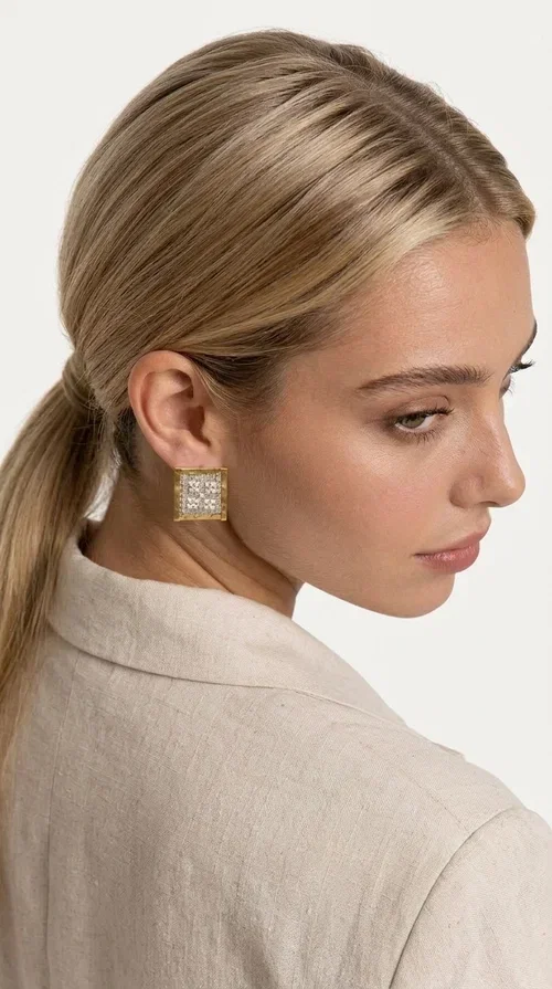 The embroidered statement earrings with geometric patterns in a cream shade are the ideal choice for those seeking an accessory with character and handmade finesse. With a square shape and detailed embroidery covering their entire surface, they form a unique piece of jewelry that combines traditional techniques with a contemporary aesthetic.

Designed by Greek Jewelry Designer Aikaterini Chalkiadaki, these handmade earrings are crafted from brass and fabric, creating a striking combination of materials. The geometric embroidery in cream tones gives off a warm, boho-chic vibe that suits both casual and formal looks alike — from an everyday stroll to a wedding or christening.

These square-shaped stud earrings sit comfortably on the ear and allow for hair-up styling, as shown in the image, fully highlighting their elegant geometry. Ideal as a gift for women who appreciate unique, handmade jewelry of Greek design.