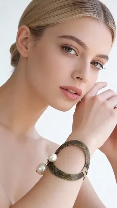 Stand out with this impressive statement bracelet that combines the magic of pearls with the mystery of black color. Designed by Greek Jewelry Designer Aikaterini Chalkiadaki, this handmade piece is the perfect choice for women who love making a bold impression.

The large bracelet features a unique combination of a black base with white pearls that create a stunning contrast. Its handmade construction ensures uniqueness in every piece, while its statement design instantly adds elegance to any look. Its ergonomic shape fits comfortably on the wrist, making it ideal for everyday or evening wear.

Pair it with simple outfits to highlight its uniqueness, or wear it on special occasions for extra glamour. Care for it with a soft cloth and avoid contact with chemicals to preserve the beauty of the pearls.