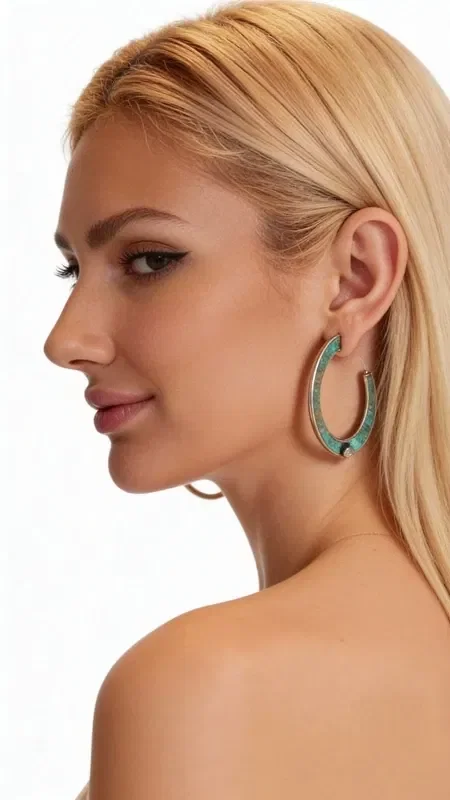 Striking hoop earrings with pearls that combine the natural beauty of copper with the elegance of pearls. These large stud earrings, designed by Greek Jewelry Designer Aikaterini Chalkiadaki, feature a unique green patina that adds vintage character and authenticity.

Each earring features a white pearl strategically placed at the bottom of the hoop, creating a perfect contrast with the oxidized copper surface. The handmade construction and natural patina make each pair unique, while the open hoop design offers comfort and style.

Ideal for women who love statement jewelry with boho elements, these earrings complete both casual and formal looks. The classic hoop shape combined with the pearl makes them suitable for weddings, special occasions, and everyday wear.