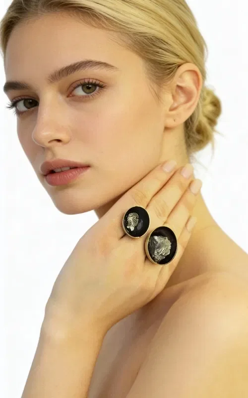 Discover the perfect balance between strength and elegance with this large statement women's ring featuring double pyrite, designed by Aikaterini Chalkiadaki. This unique handmade ring combines two natural pyrite crystals in a striking composition that catches every eye.

The black patina creates an impressive contrast with the golden pyrite crystals, while the brass adds warmth and durability to the piece. The open design of the ring allows for comfortable fit across various finger sizes, while the two oval pyrite stones in different sizes create a dynamic composition.

Pyrite is considered a stone of protection and strength, ideal for women who want to express their personality with style. This statement ring pairs perfectly with both casual and formal outfits, adding a unique character to any look.