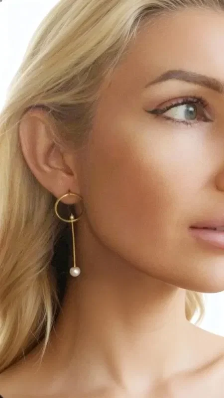 Discover the magic of asymmetric earrings with pearls, an original creation designed by Greek Jewelry Designer Aikaterini Chalkiadaki. These striking handmade earrings combine the elegance of gold-plated brass with the natural beauty of pearls.

The unique asymmetric design offers a modern take on classic dangle earrings. One earring features an elegant gold hoop with a pearl drop in a long line, while the other has a shorter length, creating a perfect balance that highlights the contemporary aesthetic. The earrings are stud-style for a comfortable and secure fit.

Made from high-quality brass with a gold finish and natural pearls, these statement earrings are ideal for weddings, formal events, or whenever you want to add a boho touch to your everyday look.