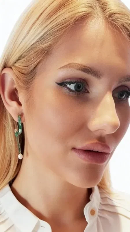 These impressive handmade stud earrings with pearls combine classic elegance with a modern aesthetic. Designed by Greek Jewelry Designer Aikaterini Chalkiadaki, they are an ideal blend of art and style that refreshes any look.

The unique geometric silhouette with the green patina creates a striking vintage aesthetic, while the white pearls at the base add classic grace. The copper has undergone a special treatment that creates its characteristic green coloring, giving each piece a distinct personality.

These dangle earrings are ideal for women who love statement jewelry with character. Their ergonomic design ensures all-day comfort, while the quality craftsmanship guarantees durability and longevity.