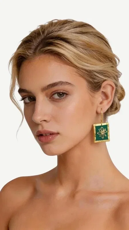 These striking embroidered statement earrings in green offer a unique aesthetic that combines the traditional art of embroidery with contemporary geometric design. Each piece, designed by Greek Jewelry Designer Aikaterini Chalkiadaki, is a work of art that transforms any look into something special.

The gold thread used creates dazzling light reflections, while the vibrant green color adds freshness and vitality. The square embroidered elements with the central geometric motif in golden tones create a refined contrast that catches the eye.

Ideal for special moments and events, these handmade earrings perfectly complement both classic and modern outfits. Their comfortable fit and lightweight feel make them suitable for all-day wear.

Material: Brass, Fabric

To preserve their beauty, store them in a dry place away from direct sunlight.