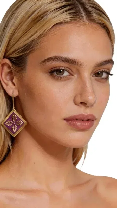 , The embroidered statement earrings with gold thread in intense burgundy color are the perfect choice for women who love striking jewelry. Designed by Greek Jewelry Designer Aikaterini Chalkiadaki, these handmade earrings combine traditional embroidery technique with contemporary geometric design. Their square shape with intricate geometric motifs creates a boho-chic style that completes both casual and formal looks. The dangle earrings are made with high-quality gold thread that creates shimmering reflections, while the deep burgundy color adds elegance and femininity. Each earring is hand-embroidered with absolute precision, making it a true wearable work of art. Statement jewelry pieces are ideal for weddings, evening outings, or whenever you want to add a striking touch to your outfit.

Material: Brass, Fabric

Take good care of them by storing them in a dry place away from moisture. Clean gently with a soft cloth when needed.