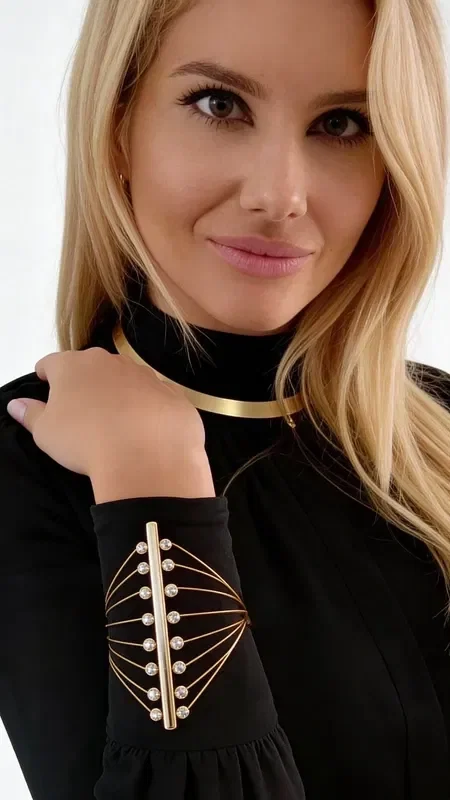Discover the perfect balance between contemporary design and classic elegance with this striking statement pearl bracelet. Designed by Greek Jewelry Designer Aikaterini Chalkiadaki, this handmade women's bracelet is a work of art that transforms any look.

The unique geometric construction in gold-toned brass creates a three-dimensional structure that holds softly glowing pearls in strategic positions. The asymmetric shape and curved lines add movement and dynamism, while the natural pearls bring classic luxury. The easy clasp ensures comfortable wear throughout the day.

This statement bracelet is ideal for pairing with monochrome outfits, adding artistic flair to your everyday style, or for special occasions that call for something extra.