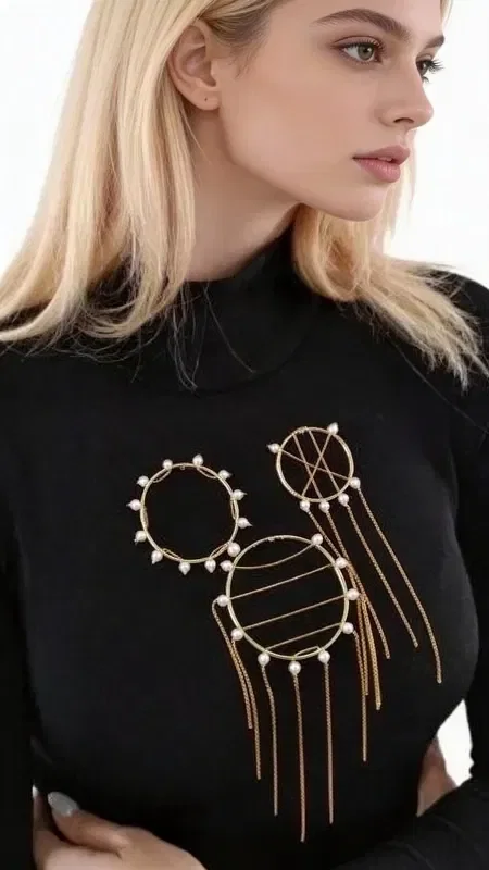 Refresh your look with this striking statement set of 3 brooches with pearls, a unique piece of jewelry that combines modern design with classic elegance. Designed by Greek Jewelry Designer Aikaterini Chalkiadaki, this handmade set includes three geometric brooches with a gold finish and white pearls.

Each brooch features a different design - a circle with pearls around its edge, a circle with horizontal lines and pearls, and a smaller brooch with dangling elements. The golden hue and elegant pearls create a harmonious ensemble that instantly adds glamour to any look. Perfect to wear together on a blouse, jacket or dress, or separately for more subtle styling.

These handmade brooches are the perfect accessory for women who love unique styling and quality jewelry. Store them in a dry place and gently clean them with a soft cloth to preserve their shine.