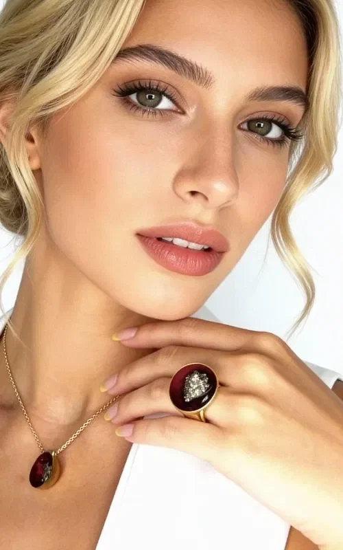 Discover the magic of handmade jewelry with this striking women's ring featuring pyrite in a burgundy hue. Designed by Greek Jewelry Designer Aikaterini Chalkiadaki, this ring combines traditional Greek craftsmanship with a modern aesthetic.

The large ring features a round surface in a bold burgundy color, at the center of which shines natural pyrite with its characteristic golden metallic sheen. The brass base offers stability and comfort when worn, while the handmade construction guarantees the uniqueness of every piece.

This statement ring is ideal for completing both everyday and evening outfits, adding a touch of authentic Greek artistry to your style. Store in a dry place and clean with a soft cloth to preserve the jewelry's shine.